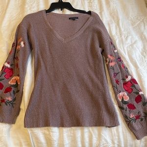 Purple sweater with floral sleeve design